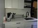 Bright kitchen featuring white cabinetry, a sink, and ample countertop space at 3610 E 28Th St, Indianapolis, IN 46218