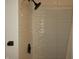 Updated shower featuring designer textured tiles and a rainfall shower head at 3610 E 28Th St, Indianapolis, IN 46218