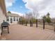 Wooden deck with black railings provides access to a sunroom, offering an inviting outdoor space for relaxation at 3791 Harveys Path, Greenwood, IN 46143