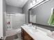 Bathroom featuring white countertops, a large framed mirror, and a combined tub and shower at 3791 Harveys Path, Greenwood, IN 46143