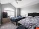 Bedroom with vaulted ceiling, neutral walls, arched window, and two beds, offering a spacious retreat at 3791 Harveys Path, Greenwood, IN 46143