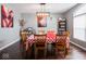 Traditional dining room featuring hardwood floors, a modern chandelier, and seating for six at 3791 Harveys Path, Greenwood, IN 46143