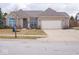 Charming brick home with a two-car garage, manicured flower beds, and covered entryway at 3791 Harveys Path, Greenwood, IN 46143