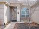 Covered entryway on a charming single-story brick home with sidelight windows and flower basket decor at 3791 Harveys Path, Greenwood, IN 46143