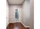 Hallway with hardwood flooring and neutral paint leads to a bathroom at 3791 Harveys Path, Greenwood, IN 46143