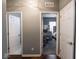 Neutral hallway featuring entryways into a bedroom and bathroom with white trim and gray walls at 3791 Harveys Path, Greenwood, IN 46143