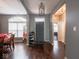 Inviting home entryway with dark hardwood floors, neutral walls, and decorative light fixture at 3791 Harveys Path, Greenwood, IN 46143