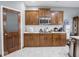 Charming kitchen featuring wood cabinets, sleek countertops, stainless steel microwave, and white subway tile backsplash at 3791 Harveys Path, Greenwood, IN 46143