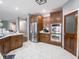 Well-appointed kitchen featuring stainless steel appliances, custom cabinets, and stylish tile flooring at 3791 Harveys Path, Greenwood, IN 46143