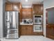 Bright kitchen boasts stainless steel appliances, wood cabinets, and sleek countertops at 3791 Harveys Path, Greenwood, IN 46143