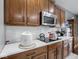Kitchen showcases wood cabinets, white countertops, and a stainless steel microwave at 3791 Harveys Path, Greenwood, IN 46143