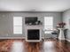 Inviting living room featuring a cozy fireplace and natural light from large windows at 3791 Harveys Path, Greenwood, IN 46143
