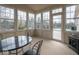 Bright sunroom featuring multiple windows, a door leading to a deck, and neutral carpeting for a relaxing atmosphere at 3791 Harveys Path, Greenwood, IN 46143