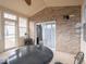 Charming sunroom with exposed brick wall and a sliding glass door offers a cozy additional living space at 3791 Harveys Path, Greenwood, IN 46143