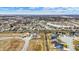 Expansive aerial view of a charming neighborhood showcasing new construction and a tranquil lake at 3801 S Cedar Creek Ln, New Palestine, IN 46163