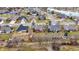 Scenic aerial view of the neighborhood showcasing the well-maintained homes and the picturesque community pond at 3801 S Cedar Creek Ln, New Palestine, IN 46163