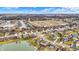 An aerial view of a new residential neighborhood with single-Gathering homes, streets, and lake at 3801 S Cedar Creek Ln, New Palestine, IN 46163