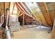 Unfinished attic space showcasing exposed beams and ample storage potential at 3801 S Cedar Creek Ln, New Palestine, IN 46163