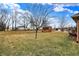 Open backyard featuring a shed and mature trees, offering a serene outdoor space at 3801 S Cedar Creek Ln, New Palestine, IN 46163
