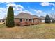 Backyard view showcasing the home's exterior, deck, lawn, and landscaping at 3801 S Cedar Creek Ln, New Palestine, IN 46163