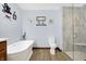 Bright bathroom showcases a soaking tub, toilet and glass-enclosed shower with a built in bench at 3801 S Cedar Creek Ln, New Palestine, IN 46163