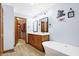 Bright bathroom shows a vanity with double sinks, soaking tub, closet access, and modern fixtures at 3801 S Cedar Creek Ln, New Palestine, IN 46163