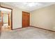 Bedroom showing neutral carpet, double door closet, and passage to hall at 3801 S Cedar Creek Ln, New Palestine, IN 46163