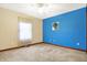 Bright bedroom features neutral carpet and a bright blue accent wall at 3801 S Cedar Creek Ln, New Palestine, IN 46163