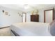 Spacious bedroom with ceiling fan, neutral walls, and a view of the ensuite bathroom at 3801 S Cedar Creek Ln, New Palestine, IN 46163