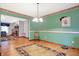 Charming dining room with hardwood floors, green walls, and decorative wallpaper border at 3801 S Cedar Creek Ln, New Palestine, IN 46163