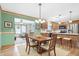 Dining room with wood table set, flowing into kitchen with island and additional seating at 3801 S Cedar Creek Ln, New Palestine, IN 46163