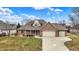 Charming brick home with a well-manicured lawn and a three-car garage at 3801 S Cedar Creek Ln, New Palestine, IN 46163