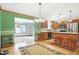 Eat-in kitchen featuring wood cabinets, stainless steel appliances, and breakfast bar with seating for two at 3801 S Cedar Creek Ln, New Palestine, IN 46163