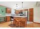 Kitchen with wood cabinets, stainless appliances, tile backsplash, and island with bar seating at 3801 S Cedar Creek Ln, New Palestine, IN 46163