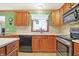 Close-up of kitchen featuring wood cabinets, tile backsplash, and modern stainless steel appliances at 3801 S Cedar Creek Ln, New Palestine, IN 46163
