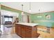 Spacious kitchen island with wooden cabinets, tile floors, and an open layout to living room at 3801 S Cedar Creek Ln, New Palestine, IN 46163