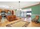 Open concept layout with kitchen island, dining area, and living room featuring hardwood floors at 3801 S Cedar Creek Ln, New Palestine, IN 46163