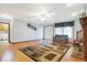 Bright living room with hardwood floors, area rug, and a comfortable sofa near the window at 3801 S Cedar Creek Ln, New Palestine, IN 46163