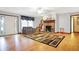 Bright living room featuring hardwood floors, a fireplace, and a staircase at 3801 S Cedar Creek Ln, New Palestine, IN 46163