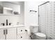 Modern bathroom boasts a sleek vanity, toilet, and minimalist shower curtain at 3840 Knollton Rd # A, Indianapolis, IN 46228