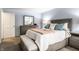 This bedroom features a queen bed, matching dresser, a mirror and soft blue walls at 3840 Knollton Rd # A, Indianapolis, IN 46228