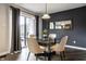 Dining room with glass table, modern chairs, gray accent wall, and sliding glass door at 3840 Knollton Rd # A, Indianapolis, IN 46228