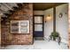 Townhouse entrance featuring brick, door, mailboxes, and decorative flowers at 3840 Knollton Rd # A, Indianapolis, IN 46228