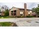 Exterior view of a two-story brick home with private patios and mature landscaping at 3840 Knollton Rd # A, Indianapolis, IN 46228