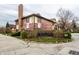 Exterior view of brick homes behind community signage and mature landscaping at 3840 Knollton Rd # A, Indianapolis, IN 46228