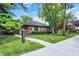 Exterior view of brick building featuring a sidewalk, lawn, and mature landscaping at 3840 Knollton Rd # A, Indianapolis, IN 46228