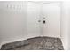 Bright hallway with coat rack, tile flooring, and neutral paint, connecting the entrance to other rooms at 3840 Knollton Rd # A, Indianapolis, IN 46228