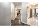 Hallway view leading to living room with fireplace and kitchen with modern appliances and dining area at 3840 Knollton Rd # A, Indianapolis, IN 46228