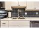 Updated kitchen with stainless steel appliances, white cabinets and black subway tile backsplash at 3840 Knollton Rd # A, Indianapolis, IN 46228
