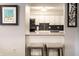 View of an updated kitchen with white cabinets and bar stool seating from the dining area at 3840 Knollton Rd # A, Indianapolis, IN 46228